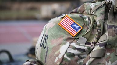 Ein Aufnäher in Form der US-Flagge ist an der Uniform eines US-Soldaten angebracht.