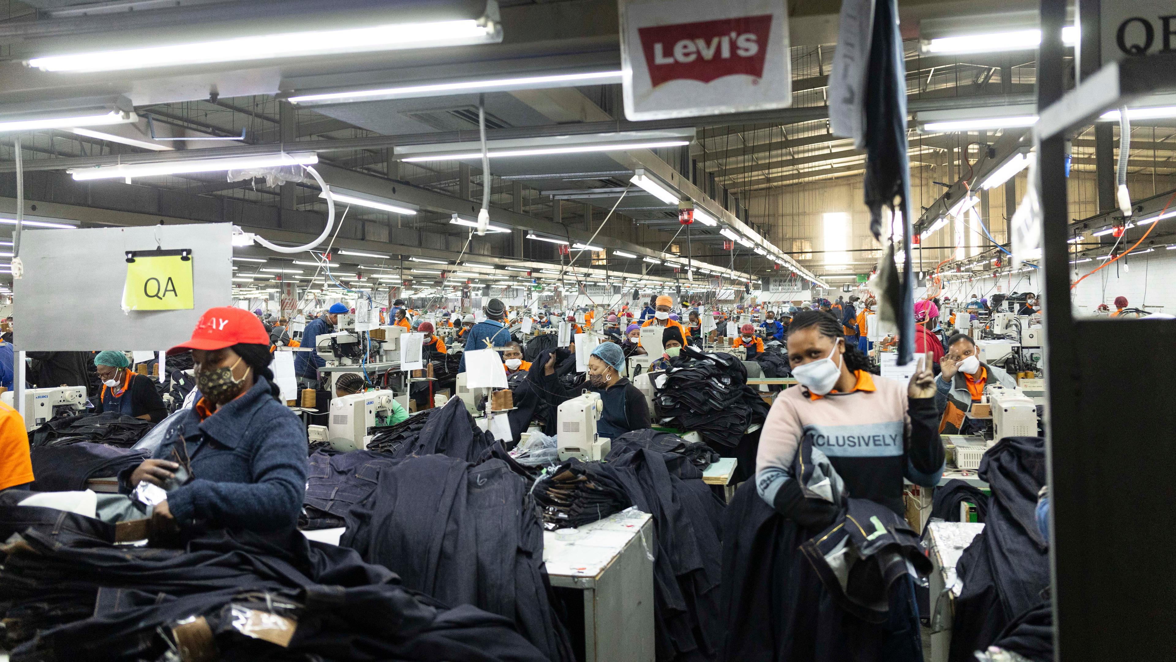 Workers at the Nien Hsing International Garment's Factory produce Levi jeans for the US market in Maseru, Lesotho.