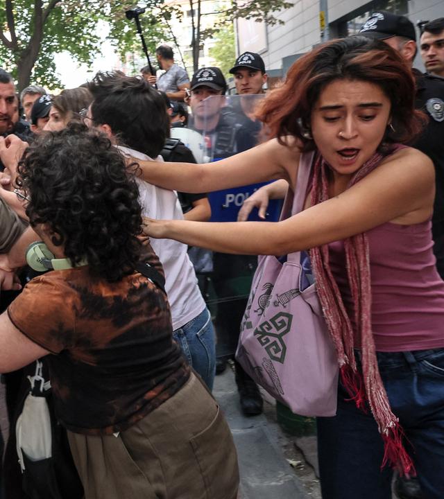 Turkish anti riot police officers clash with protesters during a demonstration against the arrests and growing targeting of LGBTQ activists in Ankara, on September 15, 2026. Turkish police arrested dozens of people on September 13 in gay bars and at the homes of LGBTQ activists on charges including "obscenity", "assisting prostitution" and having "financial links abroad". Authorities have blocked social media accounts belonging to human rights defenders and media outlets as part of operations dubbed "My Family Is Safe.