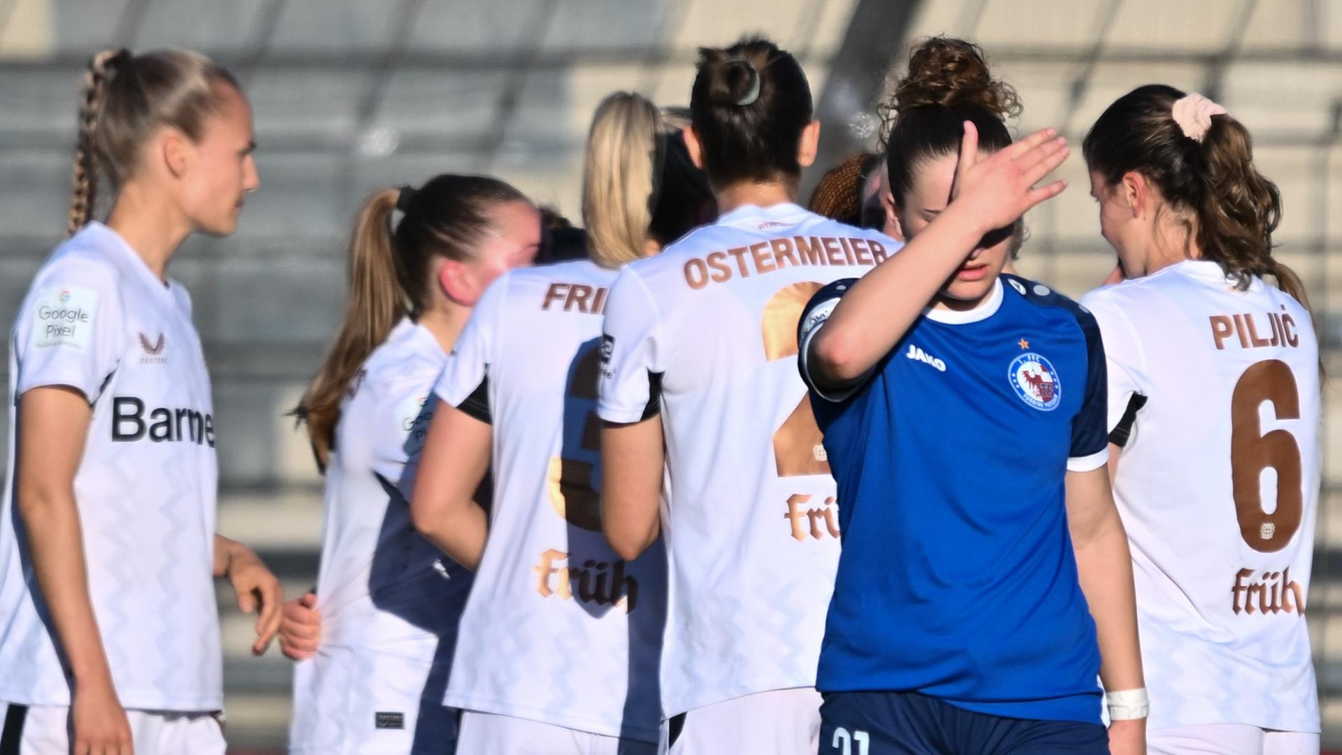 Potsdams Alina Gnädig vor den jubelnden Spielerinnen aus Leverkusen.