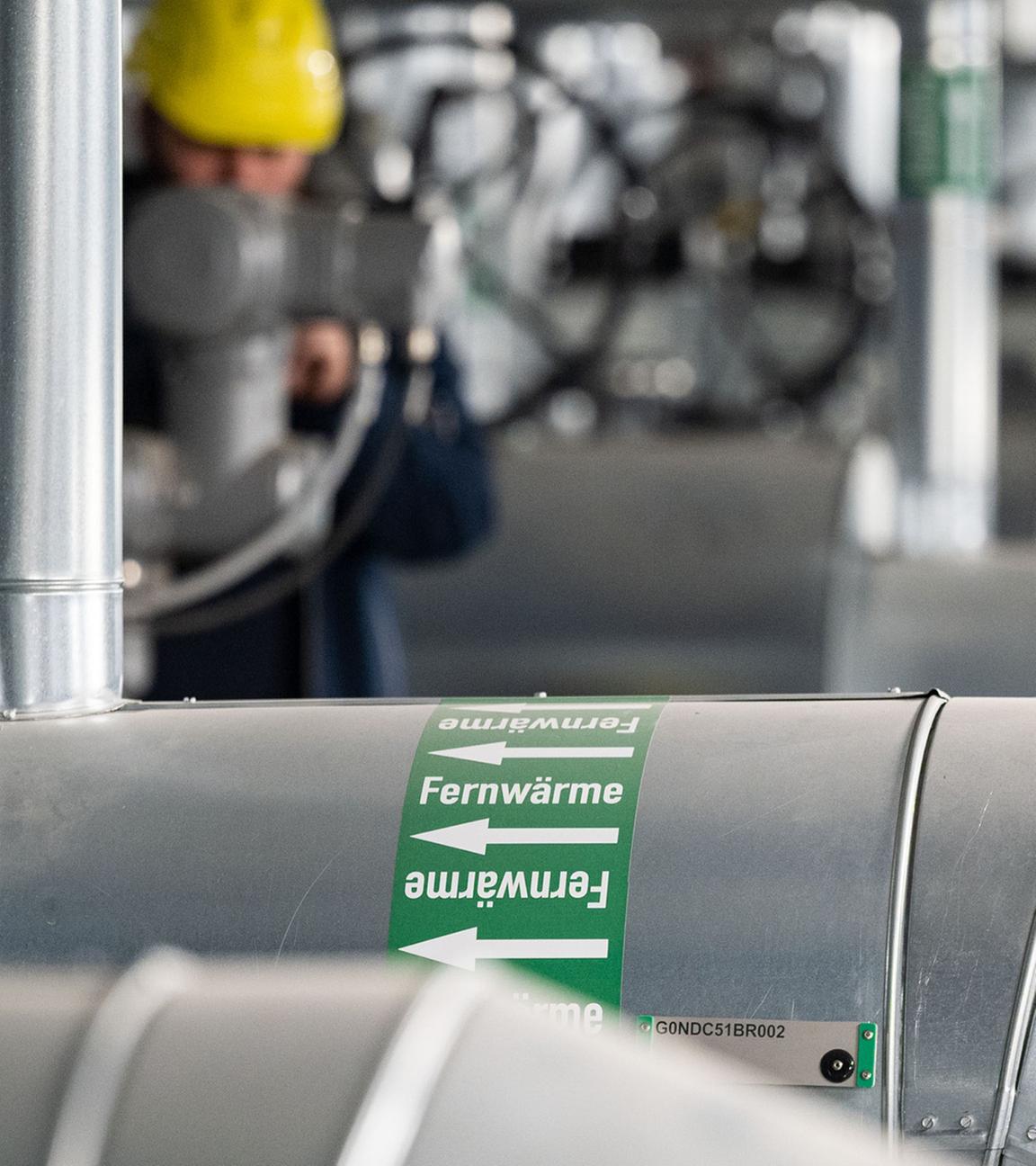 Ein Mitarbeiter des Energiekonzerns EnBW kontrolliert die Fernwärmeverteilerstation eines Heizkraftwerks.