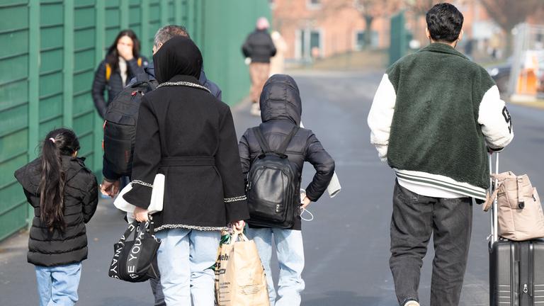 Flüchtlinge gehen in der hessischen Erstaufnahmeeinrichtung für Flüchtlinge in Gießen zu einer Unterkunft. (Archiv)