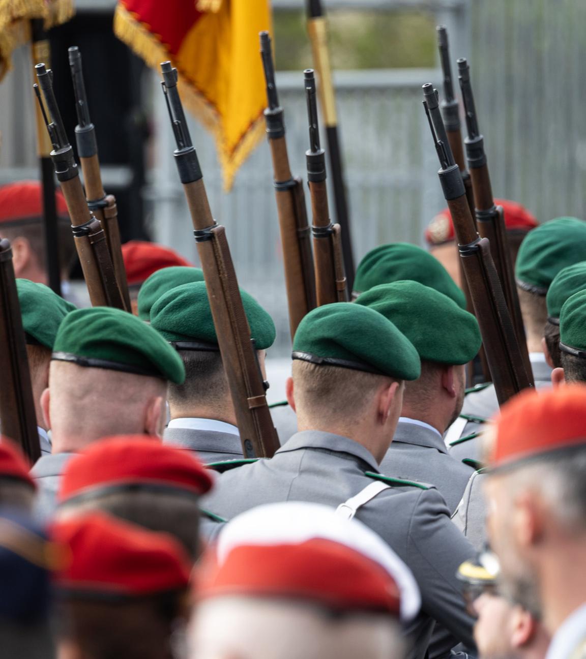 Soldaten der Bundeswehr laufen mit geschulterter Waffe während einer Veranstaltung.
