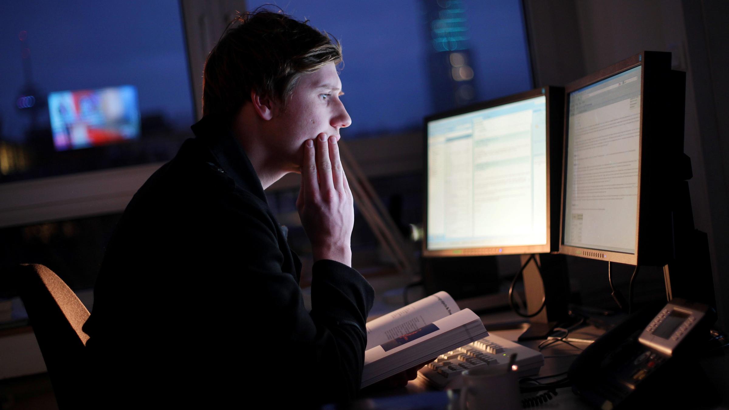 Ein Mann sitzt am Montagabend (28.11.2011) in einem Büro in Köln an seinem Computer-Arbeitsplatz. 