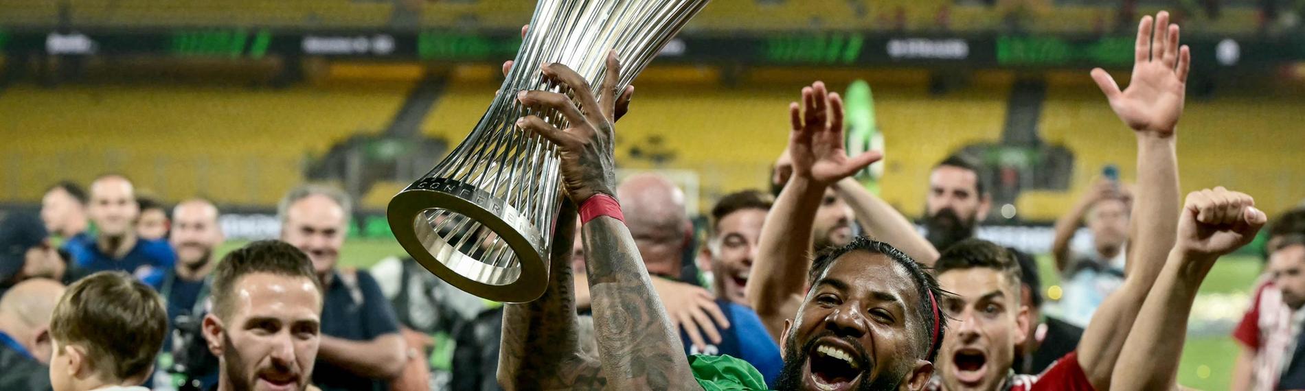 Verteidiger Rodinei von Olympiakos Piräus hält nach dem Sieg im Finale die Trophäe der UEFA Europa Conference League.