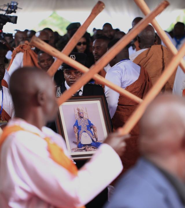 Ein ugandischer Sicherheitsbeamter trägt ein Porträt von König Oyo Nyimba aus Tooro während dessen Trauerzug in Fort Portal, Uganda, am Samstag, dem 12. September 2026.