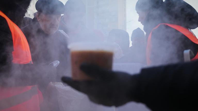 Volunteers serve free hot food to Kyiv residents during a blackout caused by Russia's regular air attacks on the country's energy system in Kyiv.