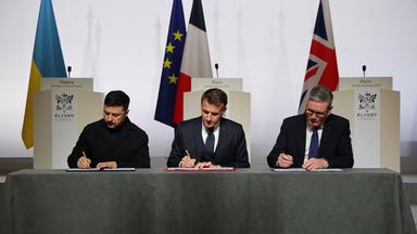 Der ukrainische Präsident Wolodymyr Selenskyj, der französische Präsident Emmanuel Macron und der britische Premierminister Keir Starmer unterzeichnen am 6. Januar 2026 im Élysée-Palast in Paris die Erklärung zum Einsatz von Streitkräften nach dem Waffenstillstand in der Ukraine. 