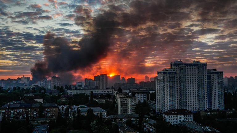 Nach einem heftigen russischen Luftangriff auf Kiew steigt bei Sonnenaufgang Rauch über der Stadt auf