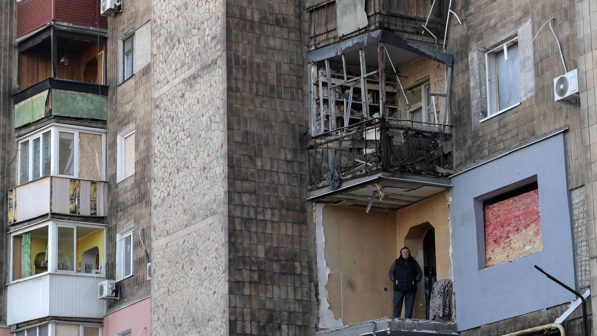 Ein Anwohner steht auf dem zerstörten Balkon einer Wohnung in einem beschädigten Wohngebäude nach einem russischen Raketenangriff in der Stadt Makiivka. 