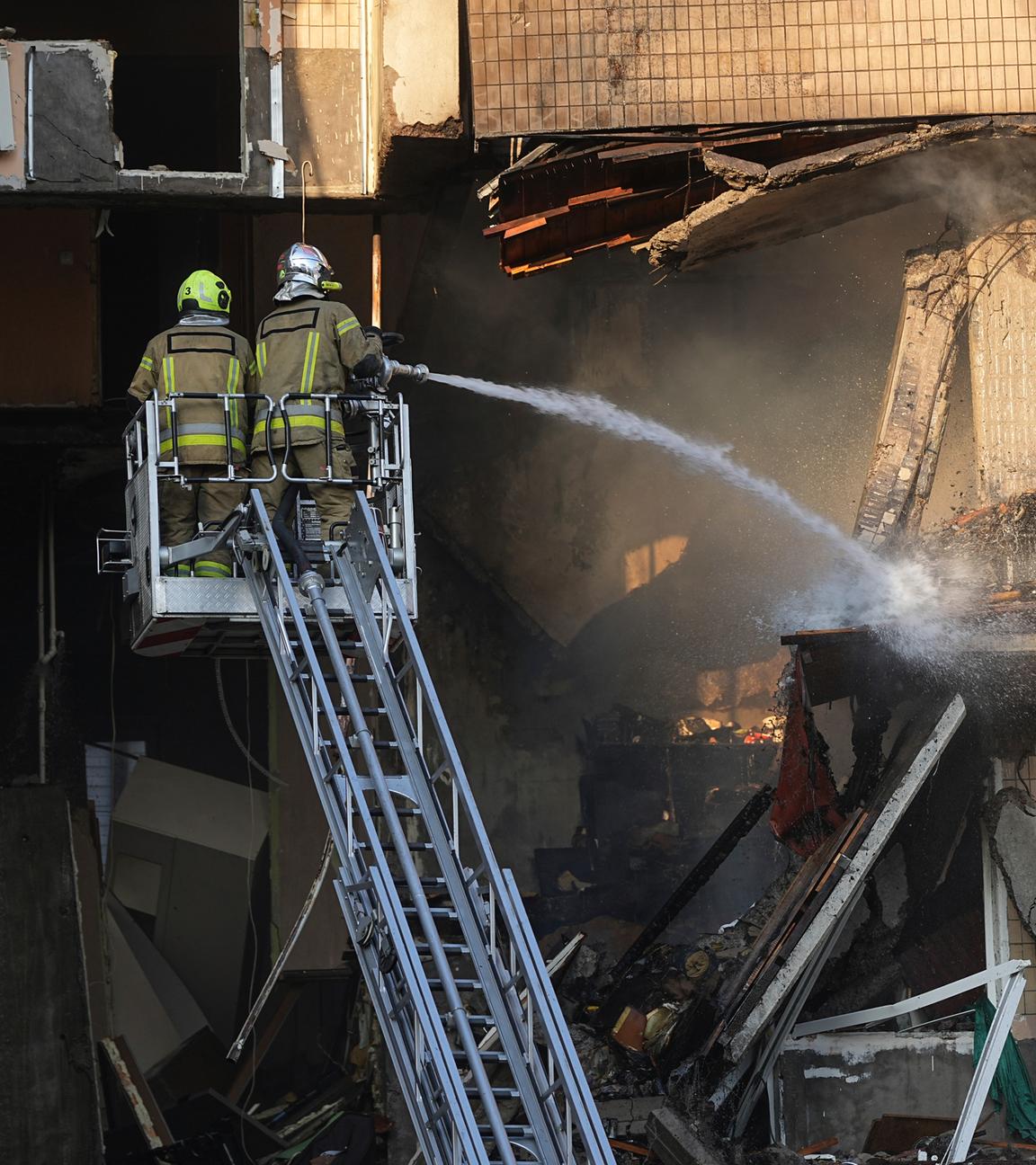 Rettungskräfte arbeiten daran, ein Feuer nach einem russischen Angriff zu löschen. 