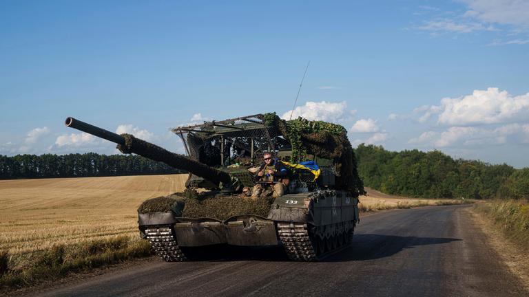 Ukrainischer Soldat sitzt auf einem erbeuteten Panzer nach seiner Rückkehr aus Russland nahe der russisch-ukrainischen Grenze in der Region Sumy, Ukraine
