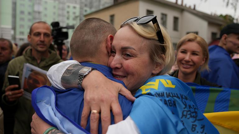 Ukrainian servicemen meet with their relatives after they were released from Russian captivity, at an undisclosed location on 06 May 2025.
