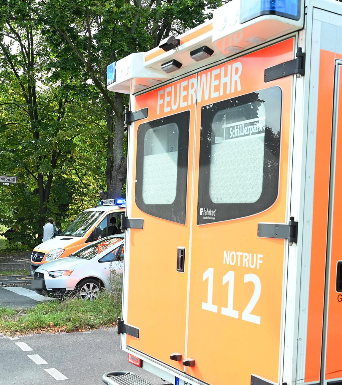 Einsatzfahrzeuge von Polizei und Feuerwehr stehen an der Unfallstelle.