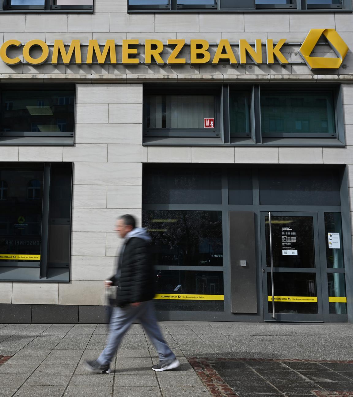 Hessen, Frankfurt/Main: Passanten gehen vor der Fassade einer Filiale der Commerzbank entlang.