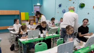 Schüler besuchen am Osterwochenende (20.04.2025) eine neu errichtete unterirdische Schule. Viele tragen traditionelle ukrainische Wyshywanka. Wegen andauernden russischen Beschusses bieten die Schutzräume einen sicheren Lernort.