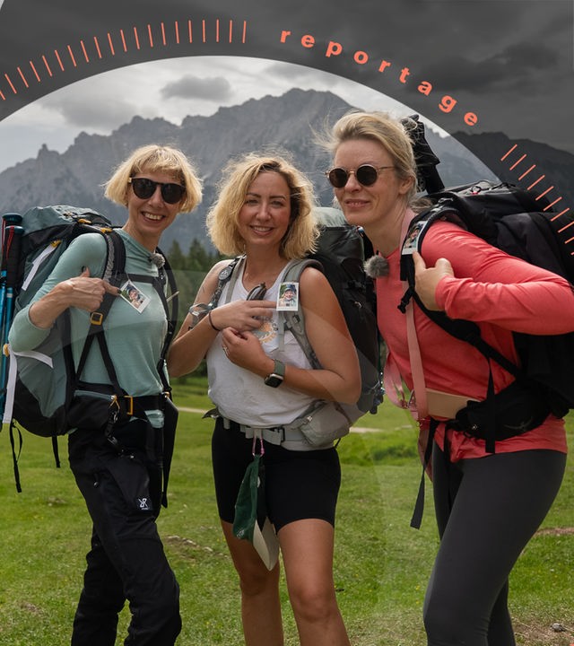 Die Freundinnen Revi, Annika und Claudia stehen nebeneinander auf einer grünen Wiese vor dem Bergpanorama des Karwendelgebirges. Sie schauen lächelnd in die Kamera.
