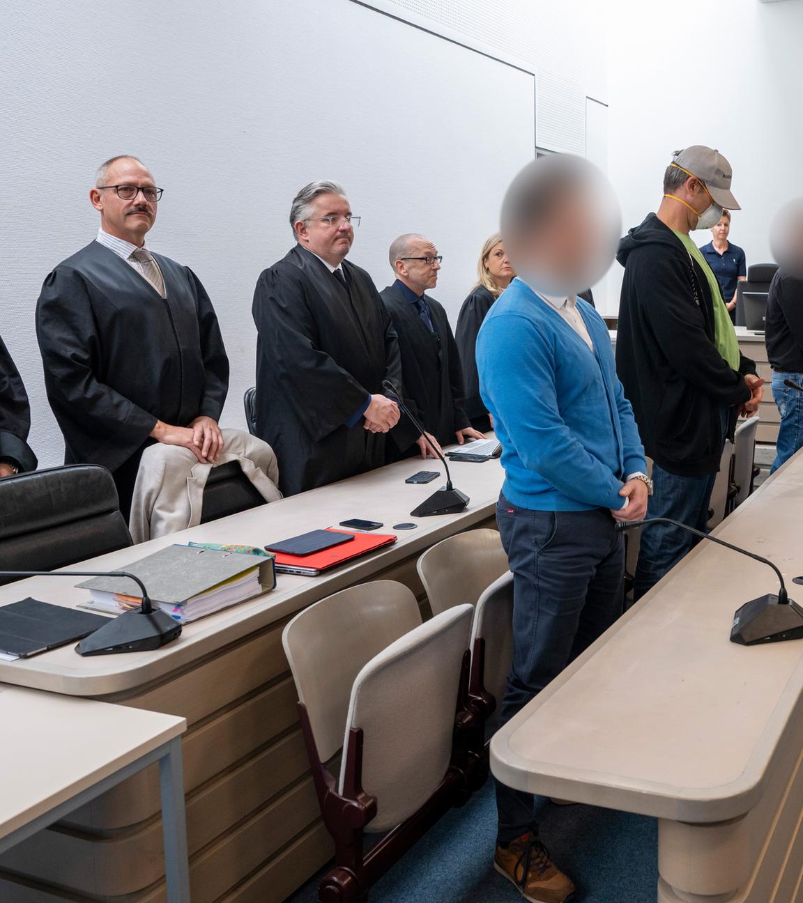 Die Angeklagten haben vor Prozessbeginn im Gerichtssaal des Landgerichts Ingolstadt ihren Platz bei den Anwälten eingenommen. 