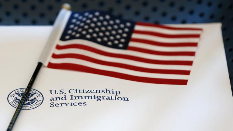 Informationsmaterial und eine amerikanische Flagge liegen im Büro der US-Einwanderungsbehörde