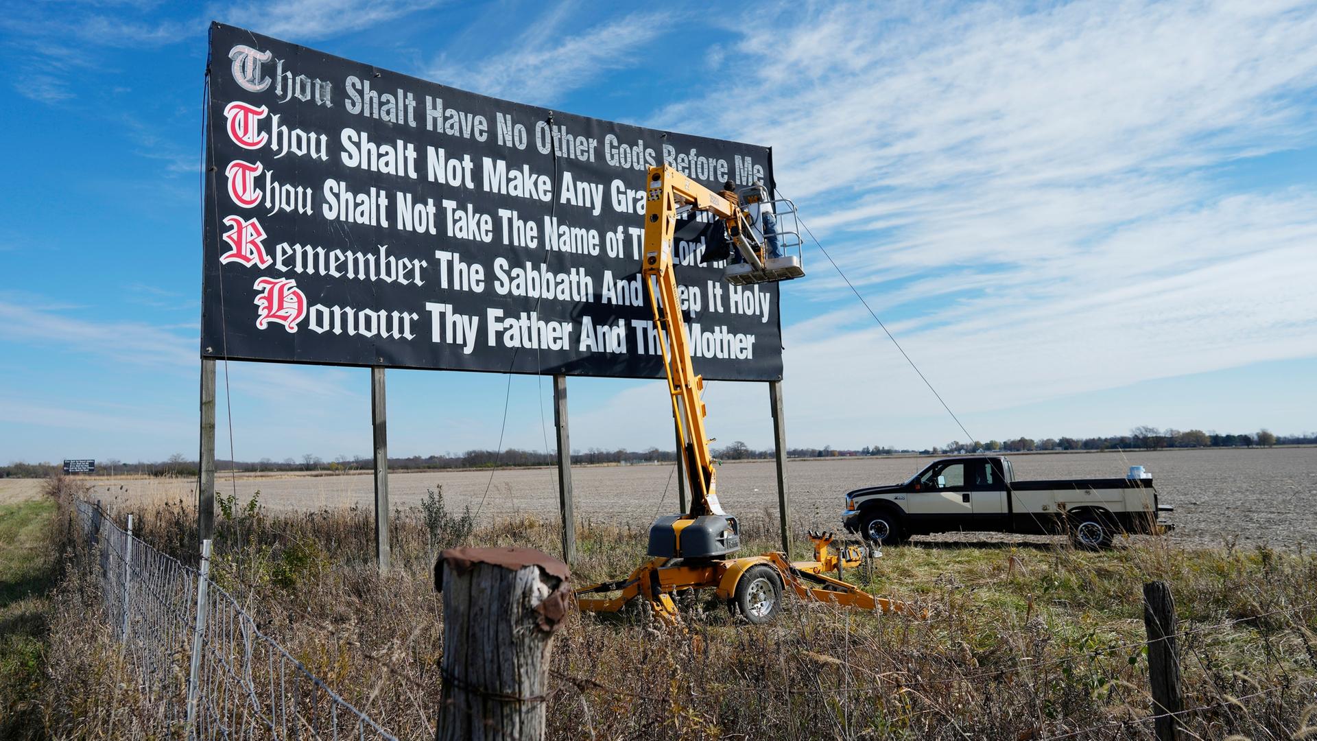 Archiv: Arbeiter streichen am Wahltag in der Nähe von Chenoweth, Ohio, Dienstag, 7. 11. 2023, eine Plakatwand mit den Zehn Geboten an der Interstate 71 neu. 