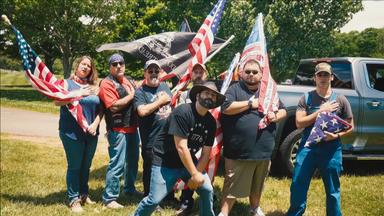 Eine Gruppe Rednecks schwenkt US-Flaggen.