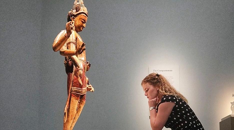 Kathryn Jones kniet vor einer Statue in einem Museum in Washington D.C.