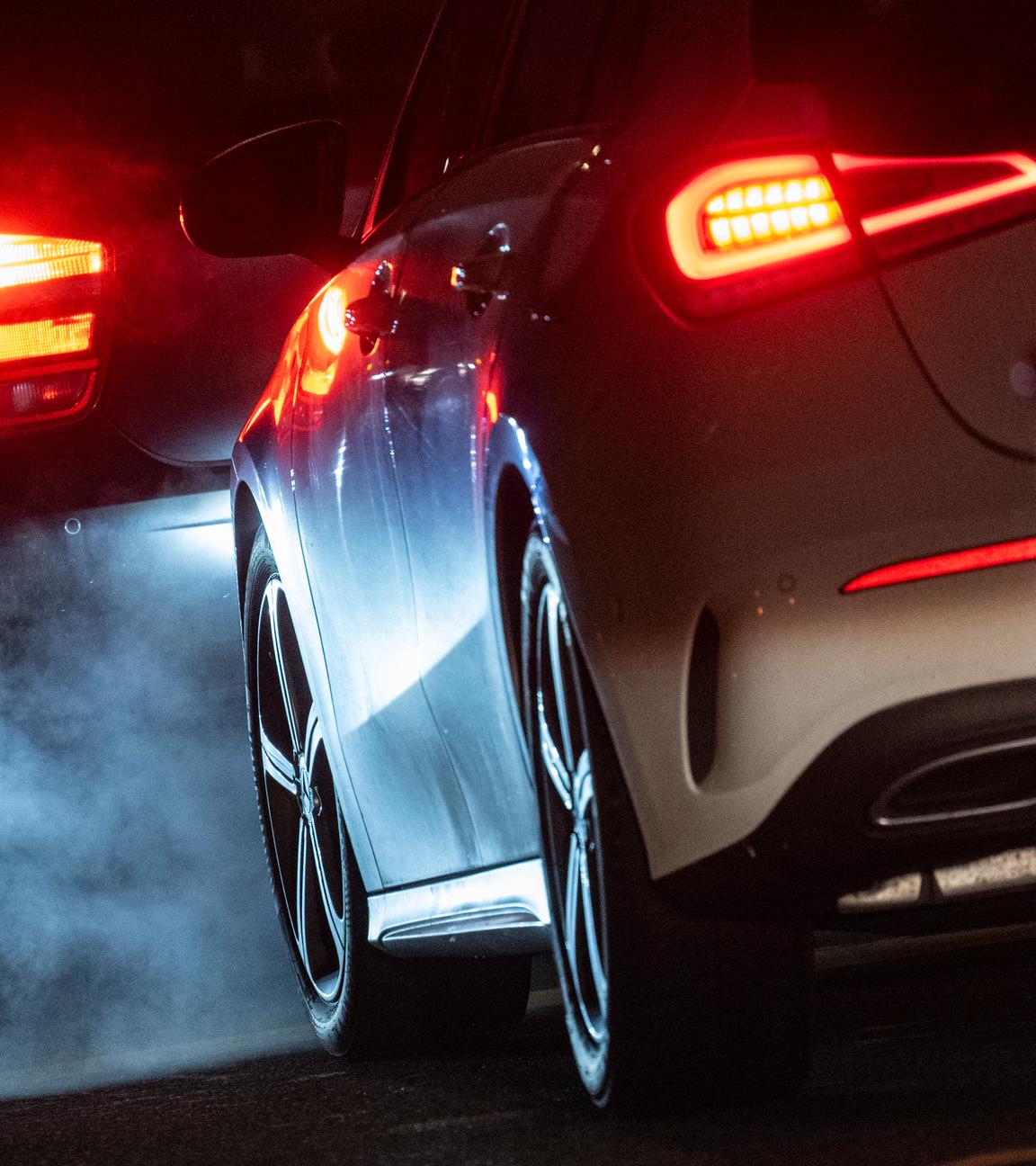 Autoabgase sind hinter einem Kraftfahrzeug im Straßenverkehr zu sehen. 