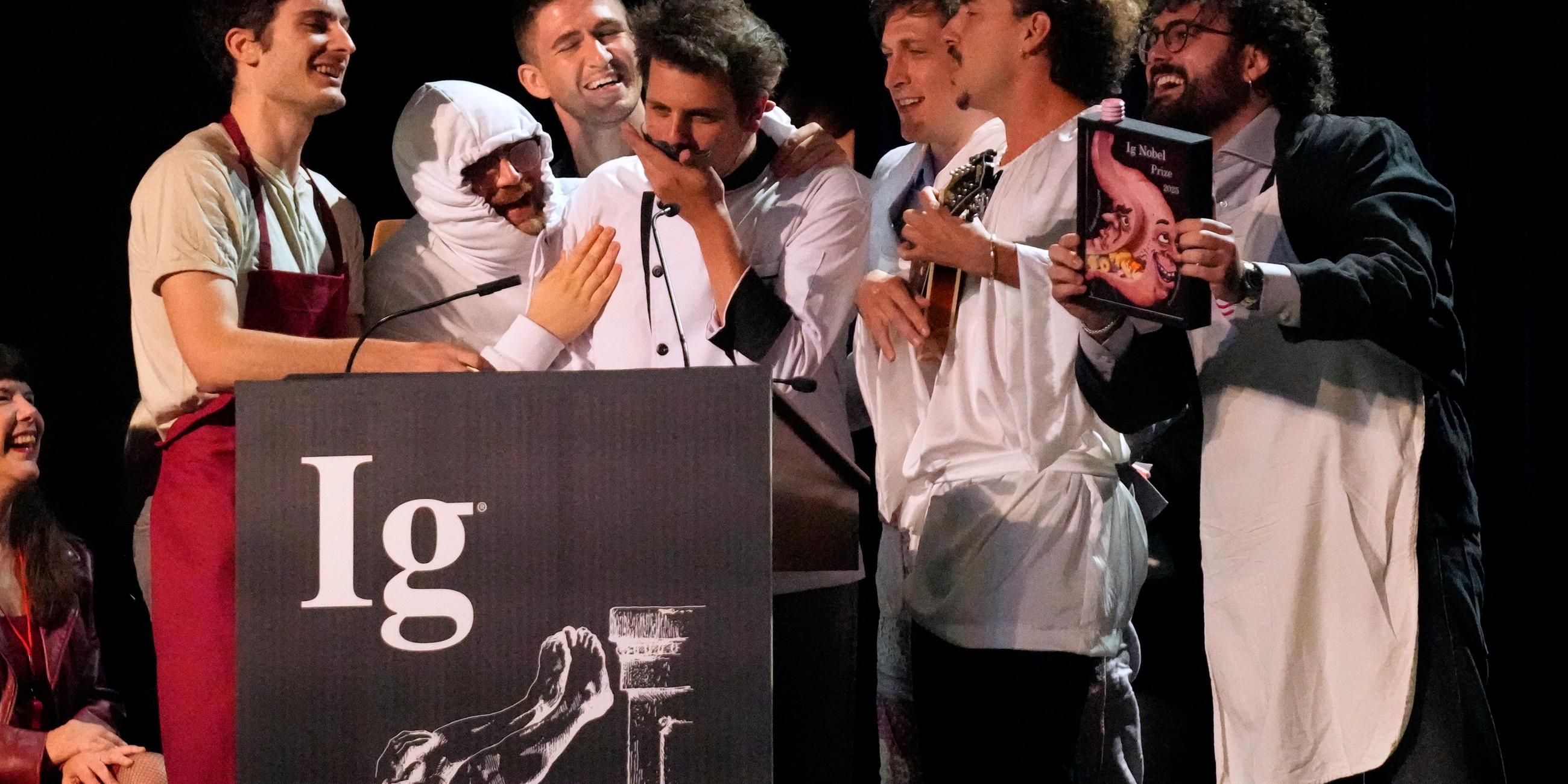 Der Ig-Nobelpreis für Ernährung wird von Daniele Dendi, Gabriel H. Segniagbeto, Roger Meek und Luca Luiselli entgegengenommen, die untersucht haben, inwieweit eine bestimmte Eidechsenart bestimmte Sorten von Pizza isst.