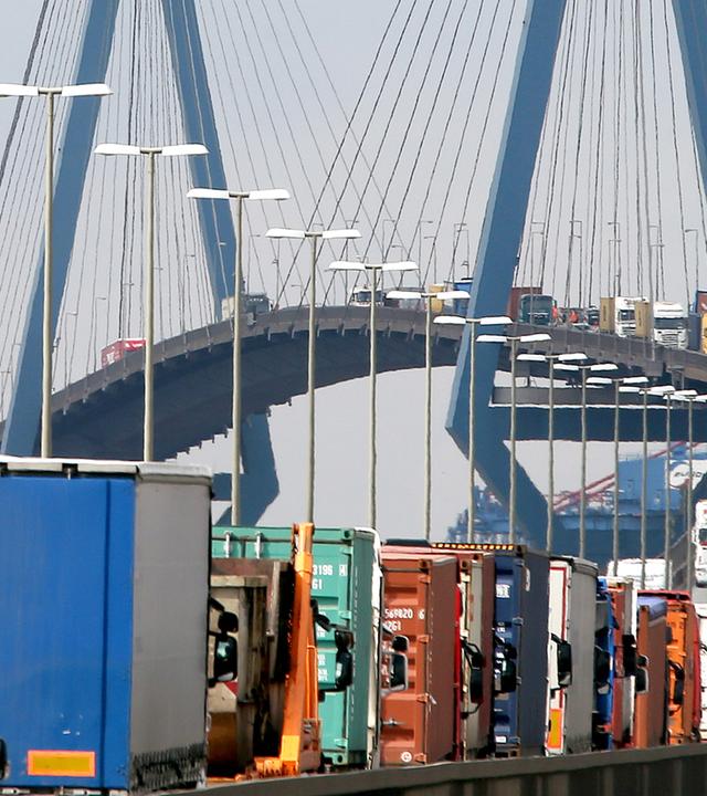 Symbolbild: mit containern beladene lastwagen stauen sich auf der koehlbrandbruecke in hamburg