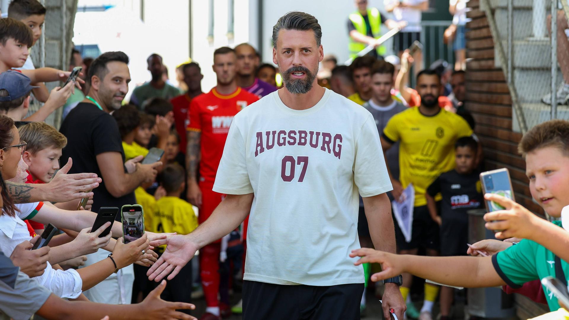 Chef-Trainer Sandro Wagner (FC Augsburg) klatscht die Fans beim Einlauf ab