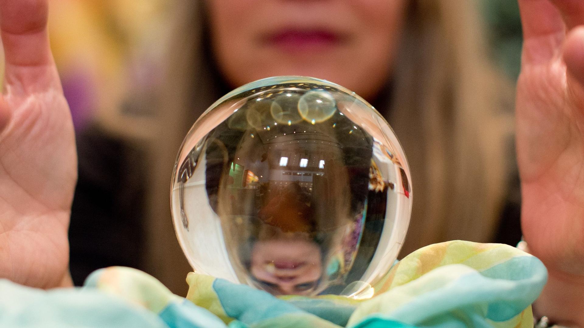 Eine Wahrsagerin blickt auf der Esoterik-Messe in Stuttgart (Baden-Württemberg) in eine Kristallkugel. Archivbild