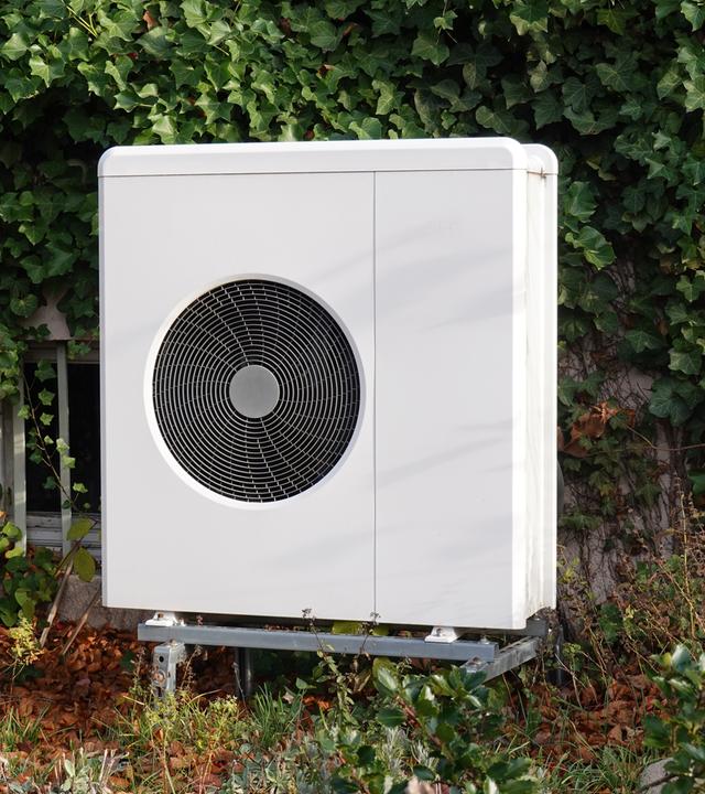 Luft-Wärmepumpe im Vorgarten zum Heizen und Kühlen von Wohngebäuden