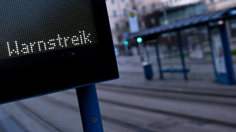 Warnstreik steht auf einer Anzeigetafel an einer Bus- und Tramhaltestelle. 