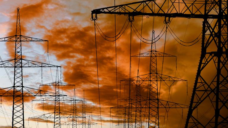 Strommasten einer Überlandleitung Strommasten einer Hochspannungsleitung vor Wolken am Himmel.