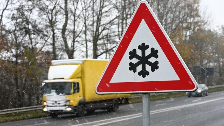  Ein Verkehrszeichen an einer Straße weist auf mögliche Glätte auf der Fahrbahn hin. Auch im Nordwesten Deutschlands herrscht winterliches Wetter.
