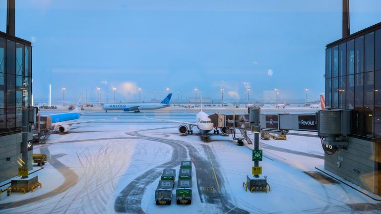Flugzeuge am schneebedeckten Hauptstadtflughafen BER. 