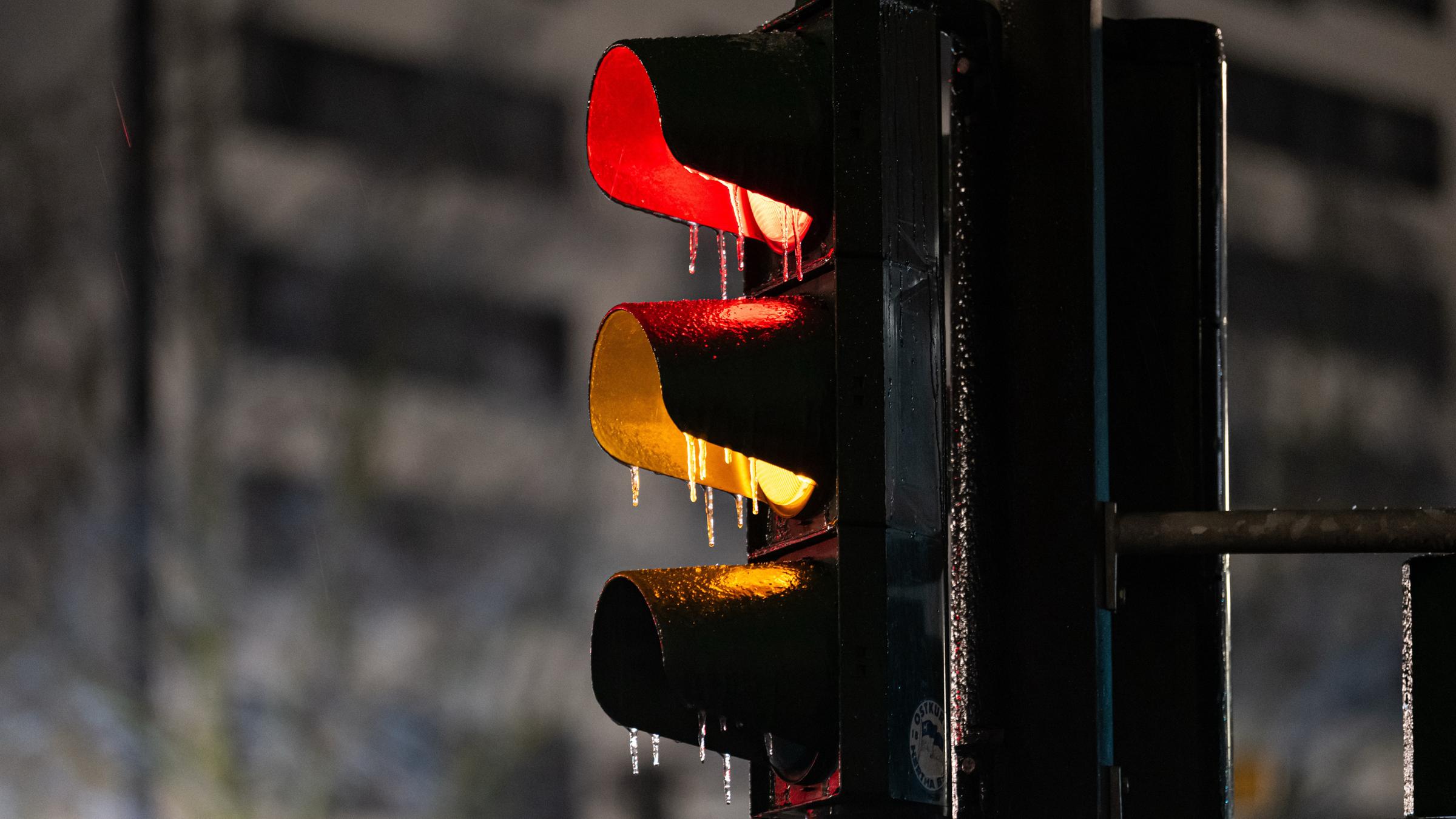 Eine dünne Eisschicht liegt am frühen Morgen vom 26.01.2026 in Berlin über einer Ampel. 