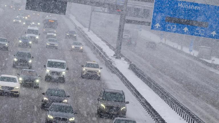 Autos und Lastwagen fahren bei Schneefall auf der Autobahn A9 im Norden von München am 12.01.2026.
