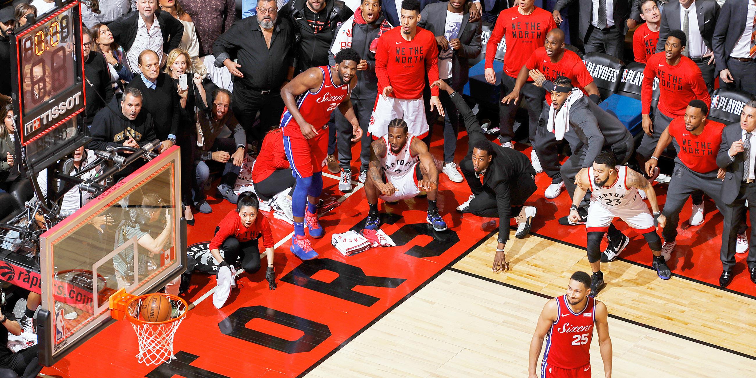 Kanada, Toronto: Kawhi Leonard (in der Hocke, mitte) von den Toronto Raptors sieht zu, wie sein Wurf ins Netz geht.