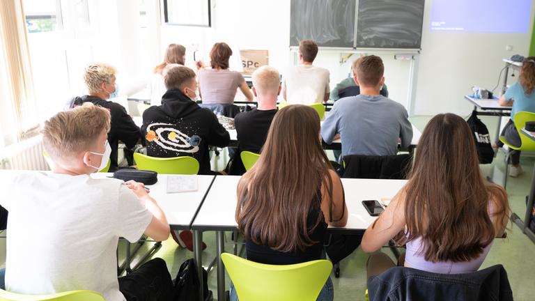 Schüler einer 12. Klasse sitzen am ersten Schultag nach den Sommerferien zu Unterrichtsbeginn im Gymnasium Bürgerwiese in einem Klassenzimmer auf ihren Plätzen. 