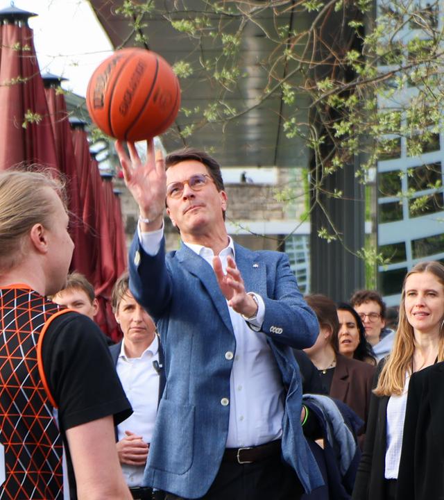 NRW-Ministerpräsident Hendrik Wüst wirft einen Basketball