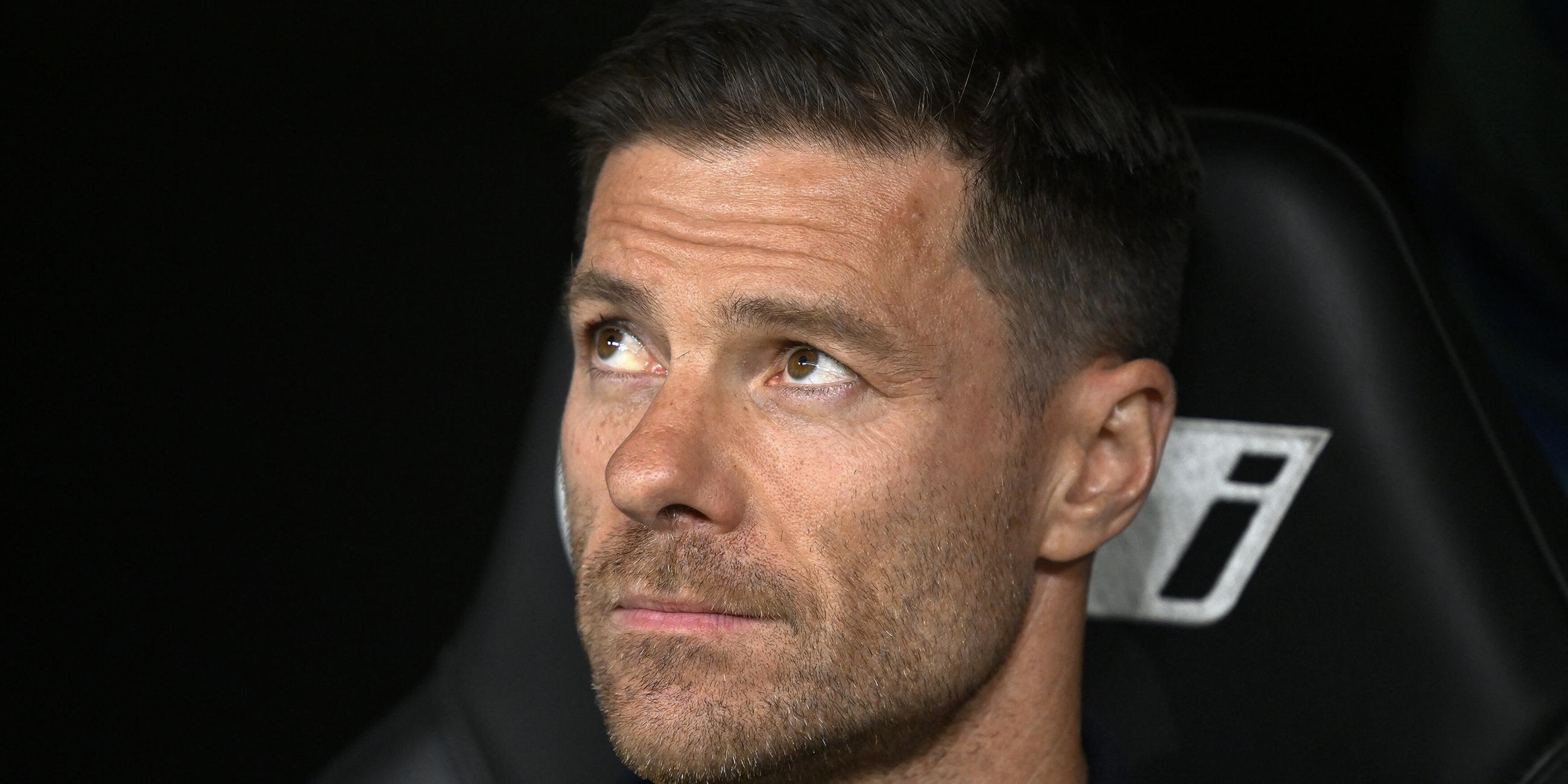 Xabi Alonso sitzt auf der Trainerbank und schaut nachdenklich nach oben