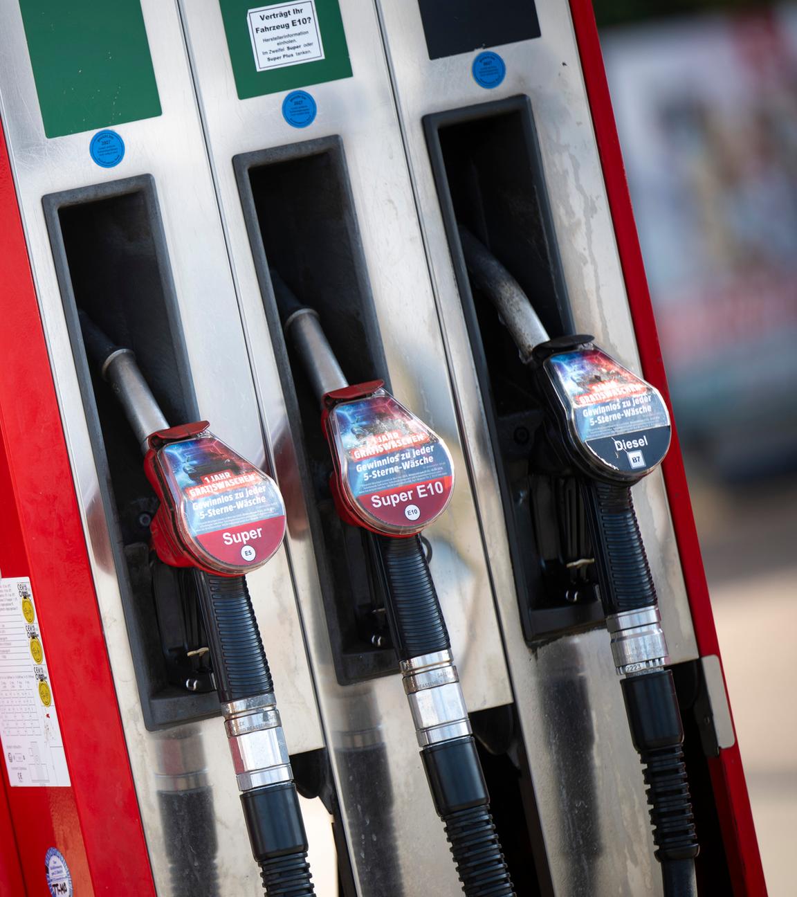 An einer Zapfsäule an einer Tankstelle hängen die Tankschläuche der Kraftstoffe Superbenzin (l-r), Super E10 und Diesel.