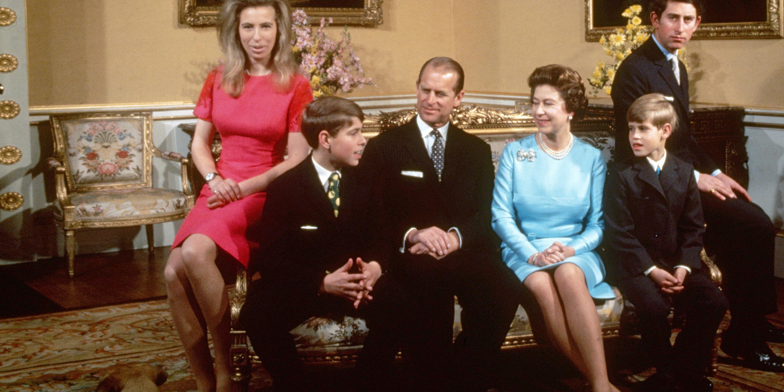 Die britische Königsfamilie rund um Queen Elizabeth II. ist auf dem Bild zu sehen. Charles und Anne auf den Armlehnen der Couch, Andrew und Edward neben ihren Eltern Philip und Elizabeth.