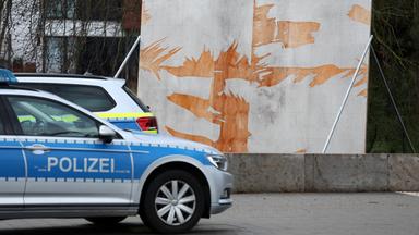 Mecklenburg-Vorpommern, Rostock: Ein Polizeiauto steht vor einem zerstörten Wahlplakat in der Innenstadt.