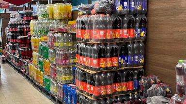 Diverse Sorten Bunte Brause Cola Saftflachen Limonade in Plastik Flaschen Plastik verpackung auf Paletten in einem Aldi Nord Discounter zum Verkauf