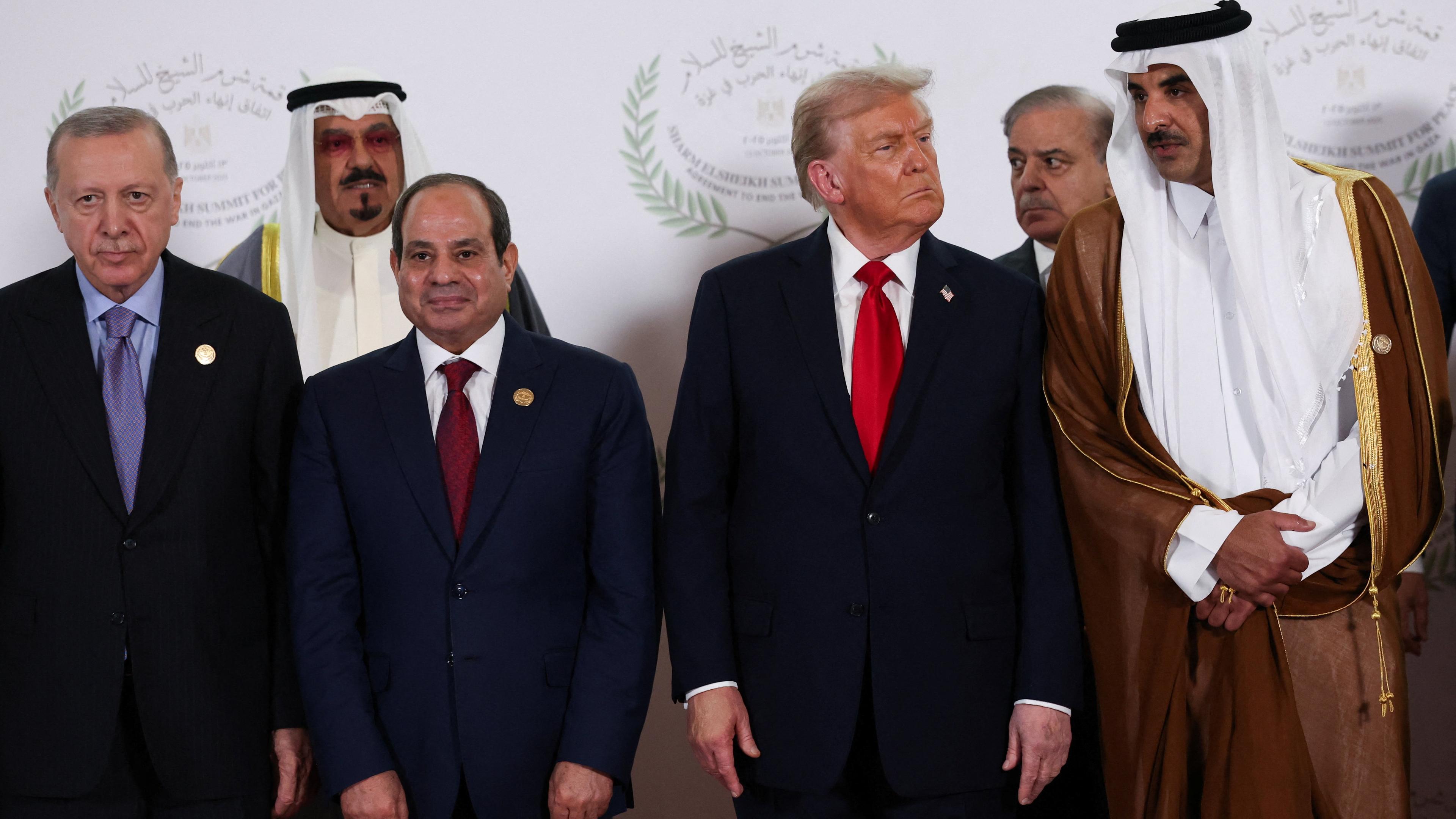 World leaders including Donald Trump, Abdel Fattah al-Sisi, Tayyip Erdogan and Emir Sheikh Tamim bin Hamad Al Thani pose for a family photo, at the Sharm El Sheikh Peace Summit in Egypt