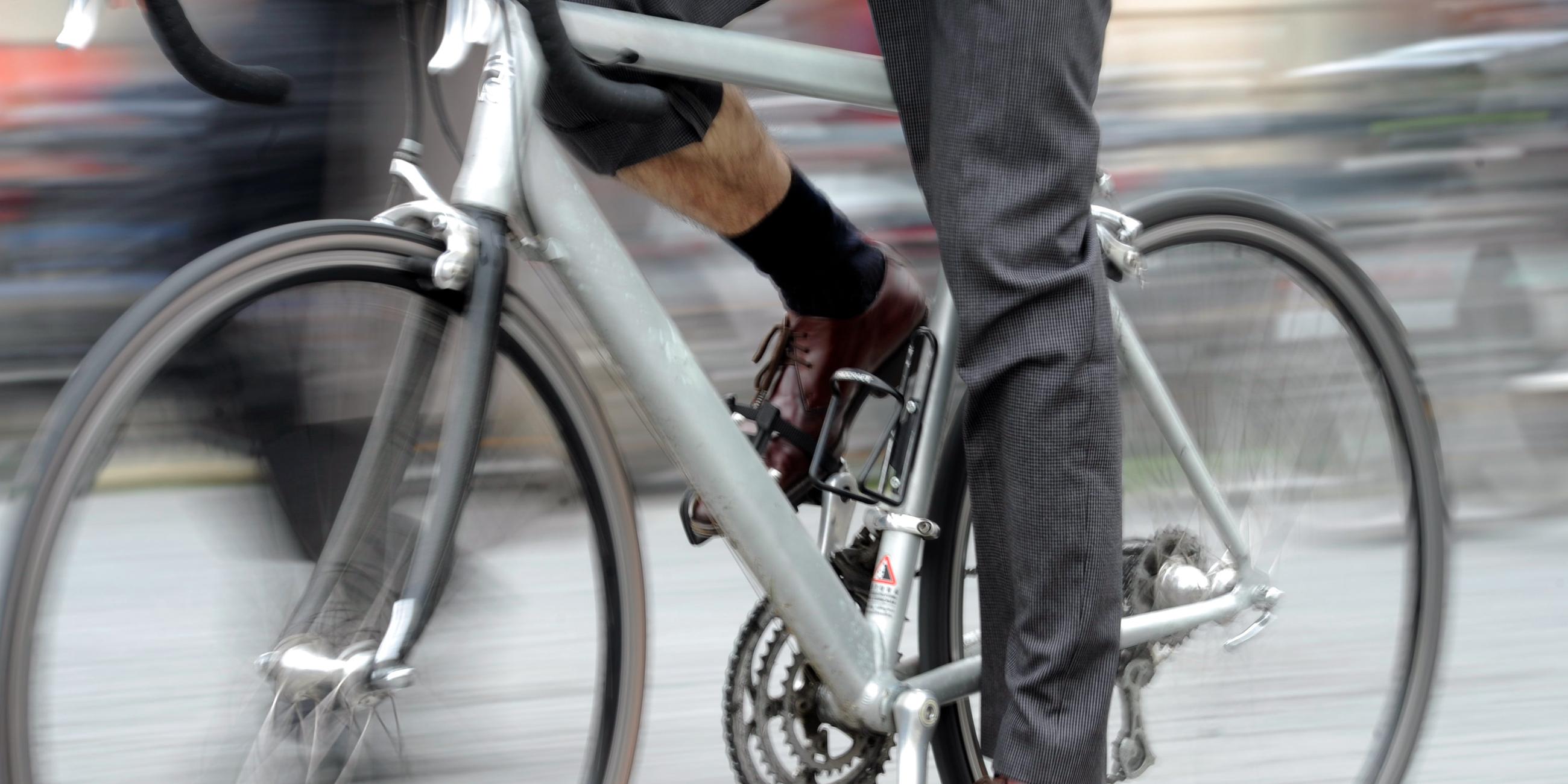Ein Fahrradfahrer mit Anzug fährt durch München.